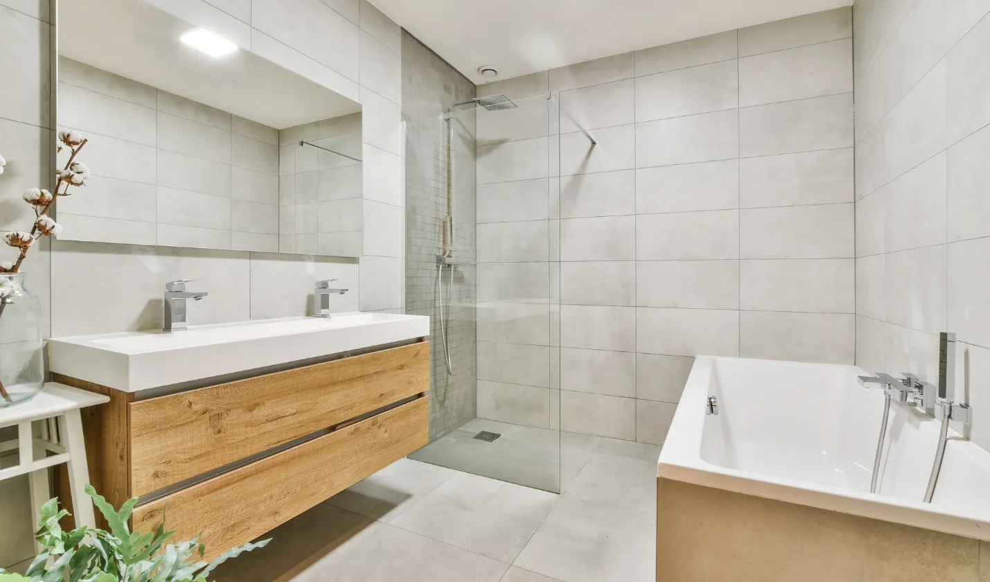 After bathroom remodeling featuring modern tile, floating vanity, updated fixtures, and clean contemporary design in Dallas, TX.