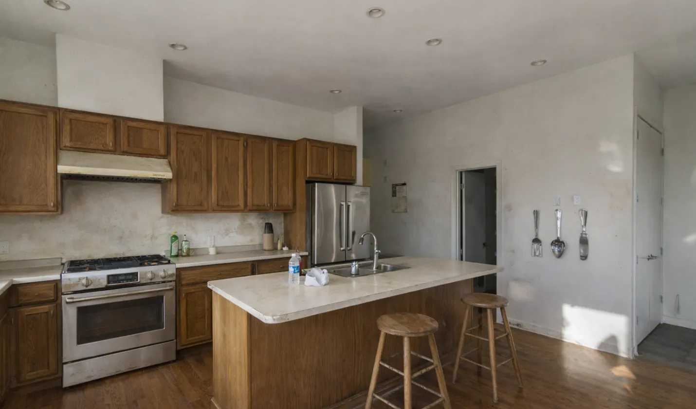 Before kitchen remodeling showing outdated wooden cabinets, worn finishes, and closed layout in Dallas home