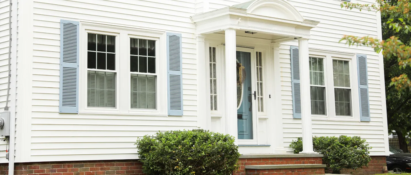 Exterior house painting service applying fresh paint to siding and trim for a clean curb-appeal finish