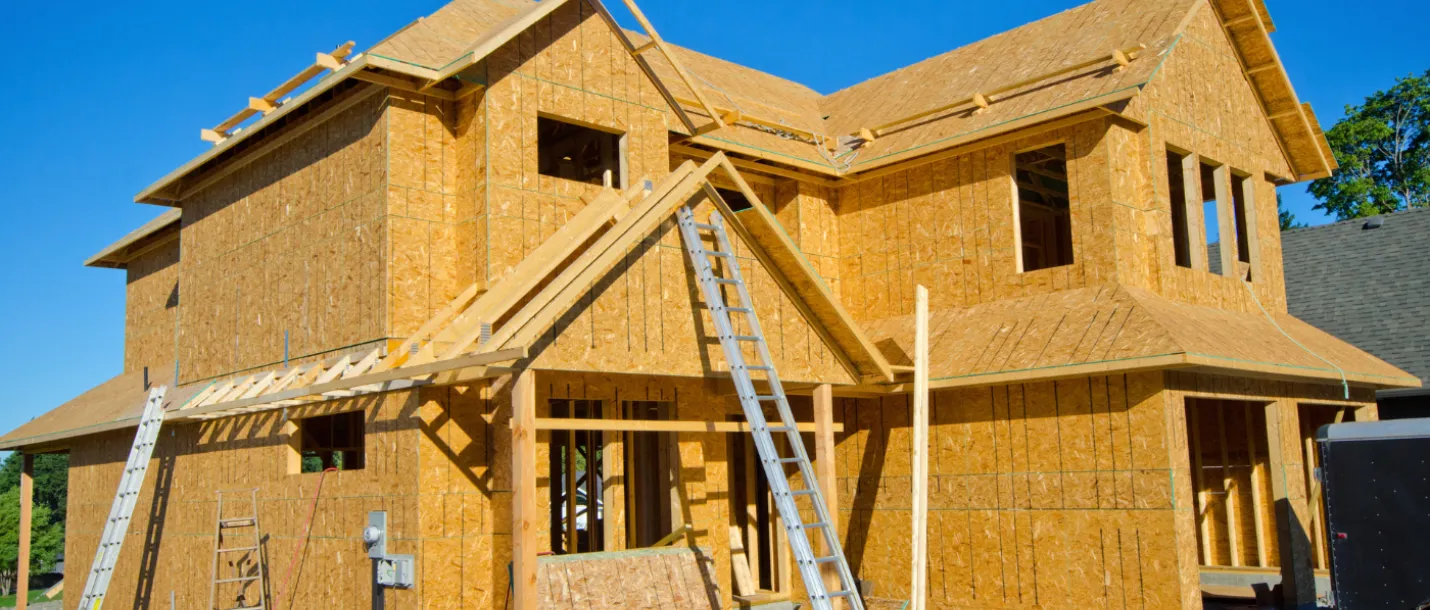 Wood framing structure of new home under construction before drywall installation